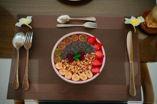 a table with a plate of food on a table at lumbung asmara in Singaraja