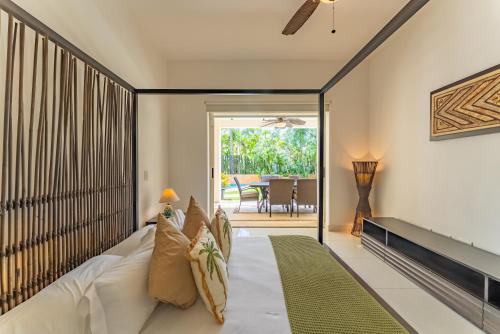 a bedroom with a bed and a sliding glass door at Spacious Apartment with Terrace, Pool and Beach Access in Puerto Aventuras