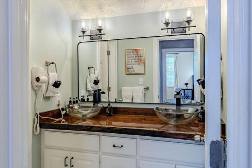 a bathroom with two sinks and a large mirror at Labrador Lake with FirePit and Billiards in Hope Mills