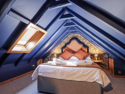 a bedroom with a blue ceiling with a bed at 83 Seatown in Buckie