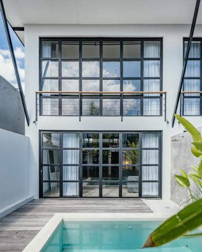 a house with a pool in front of it at Berawa Loft #2 Canggu in Canggu
