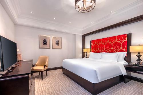 a hotel room with a large bed and a desk at The Yangtze Boutique Shanghai in Shanghai