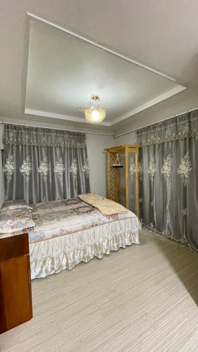 a bedroom with a large bed with gray curtains at 望月ハウス101 in Tokyo