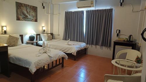 a hotel room with two beds and a window at The Sunshine hostel and hotel in Ko Lanta
