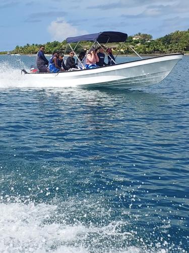 a group of people in a boat on the water at Yavu room in Rakiraki