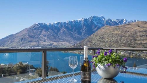 a table with a bottle of wine and a glass at Magical views Perfect place to stay in Frankton Wharf