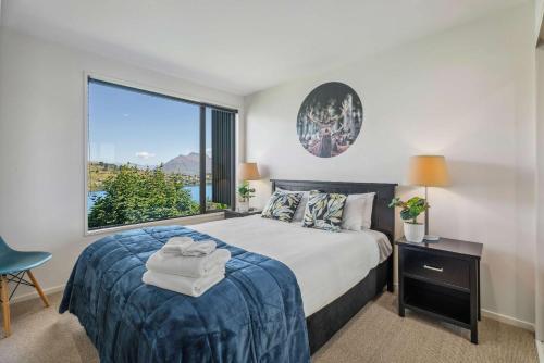 a bedroom with a bed and a large window at Magical views Perfect place to stay in Frankton Wharf