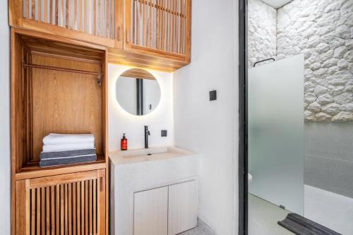 a bathroom with a sink and a mirror at Casa Santisya 4 by Orivista , 4min beach in Mengwi