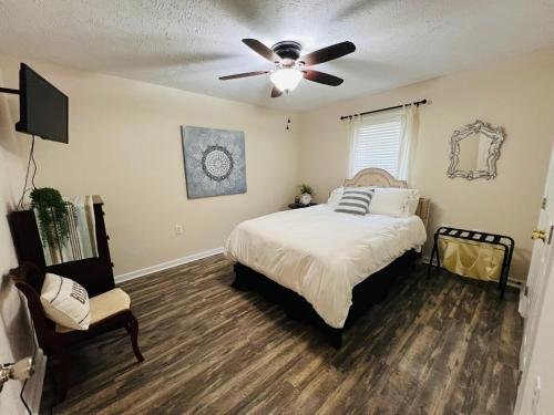 a bedroom with a bed and a ceiling fan at Tree Farm Stay Fire Pit & Grill WOW-King Suite in Fayetteville