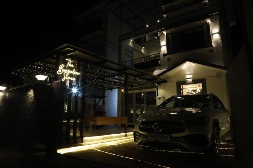 a car parked in front of a building at night at SWARAGAN HOLIDAYS VILLA 4 BHK AC LUXURY Room private pool in Lonavala