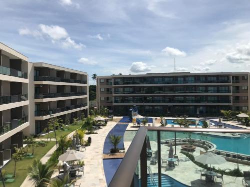 an aerial view of a resort with a swimming pool at Flat em Muro Alto, Malia Beach Experience, B114 in Porto De Galinhas