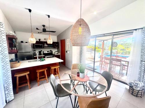 a kitchen and dining room with a glass table and chairs at Casa Bella 3 Bdrm House w Pool in Gated Community in Marbella