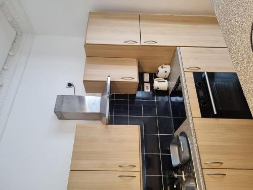 a small kitchen with a sink and wooden cabinets at Flat In Tyne Wear Sunderland in Sunderland