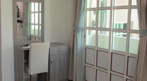 a bathroom with a door and a sink and a mirror at Sovereign Hotel - Marriage Certificate Required in Doha