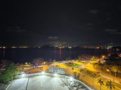 a view of a city at night with the water at Seaview Cosy BS Homestay in Kota Kinabalu