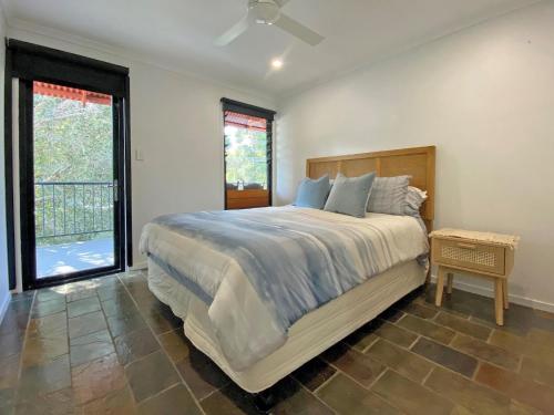 a bedroom with a large bed and a window at A Beach Affair in Amity Point