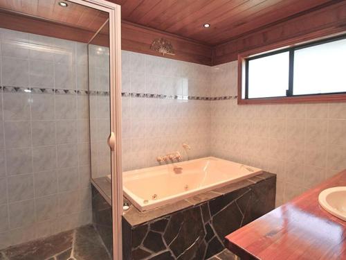 a large bathroom with a tub and a shower at After Hours 2 in Amity Point