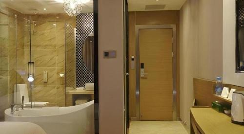a bathroom with a shower and a tub and a sink at Lavande Hotel Xian Xiaozhai Subway Station Dayanta Branch in Xi'an