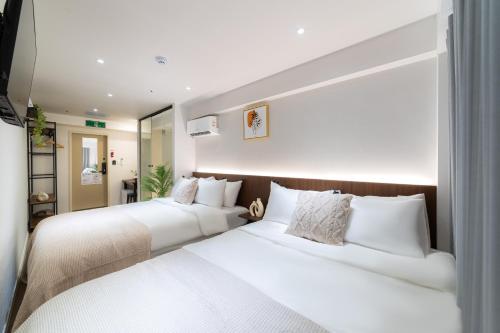 Ένα ή περισσότερα κρεβάτια σε δωμάτιο στο Haven Stay Jongno