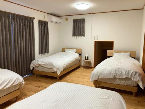 a hospital room with two beds and a window at Shinyashiki Guest House - Vacation STAY 78619v in Kumamoto