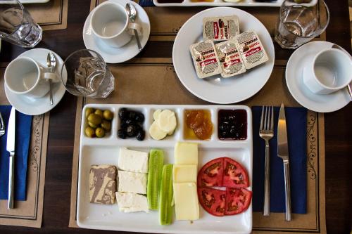 a table with a plate of cheese and other foods at Grand Bursa Hotel in Bursa