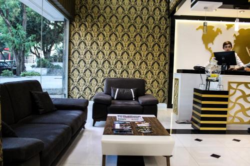 a living room with a couch and a table at Grand Bursa Hotel in Bursa