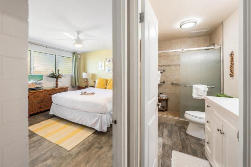 a bedroom with a bed and a bathroom at Maui Sands Seaside 713 · MSS 713 Charming 1BD Near Beach in Kahana