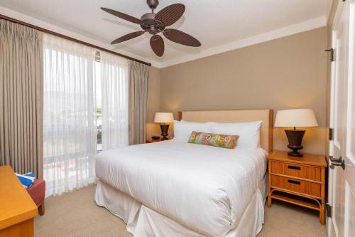 a bedroom with a white bed and a ceiling fan at Honua Kai 322 · HK 322 Luxurious Kaanapali BeachFront 2BD Pool A in Lahaina