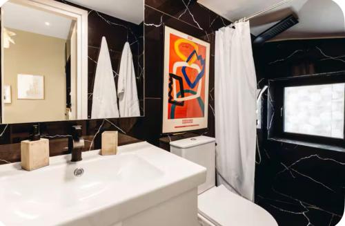 a bathroom with a white sink and a mirror at Casa Luna Luxurious comfy seaside 3persons apt in Paphos