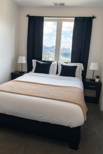 a large bed in a room with a large window at Upscale Midtown Retreat , Free Parking & Close to Mercedes-Benz in Atlanta