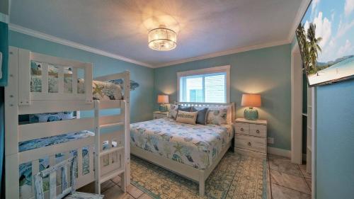 a bedroom with a bed and a bunk bed at Gulf Views Pools Tennis Pickleball Beach Access Awesome Beachfront by AvantStay in Mustang Beach