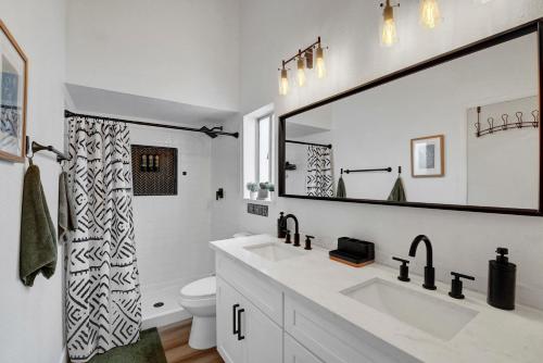 a bathroom with a sink and a large mirror at Cozy Casita, Fireplace, Backyard, Quiet in Las Vegas
