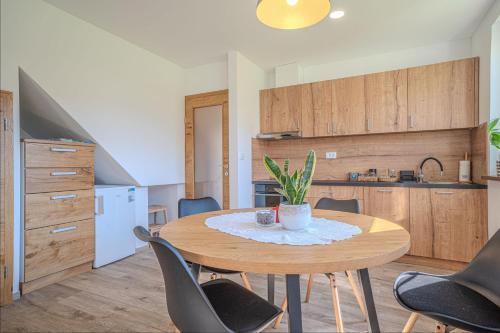 a kitchen and dining room with a table and chairs at Weiss Sport & Relax Apartment - Happy Rentals in Rečica ob Savinji