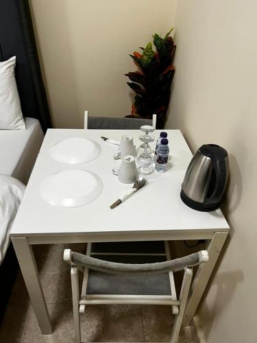 a white table with a sink in a bedroom at Bliss Spot Vacation Homes in Al Ain