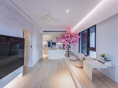 a large living room with a tree in the middle at Zzz 台北好眠 - Monthly in Taipei