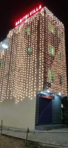 a large building with lights on it at night at Sabitri Villa in Konārka