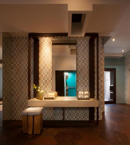 a dressing room with a mirror and a stool at Park Hotel in Desenzano del Garda