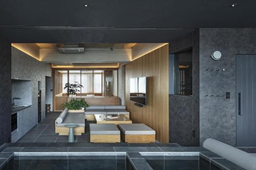 a living room with a couch and a table at YUURO Bath-Living Hotel Ryogoku in Tokyo