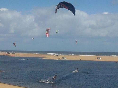 a group of people kite surfing in the ocean at Posada Azul Marino in José Ignacio
