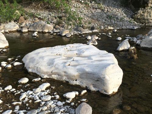 a rock in a river with snow on it at Agriturismo Fontenuova in Saturnia