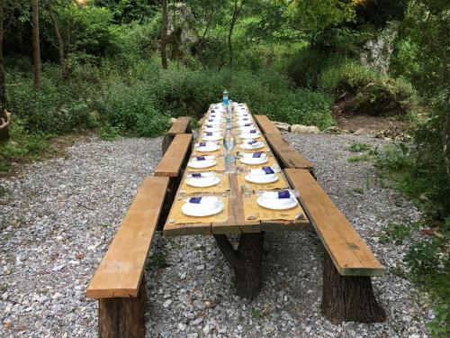 a long wooden table with plates of food on it at Agriturismo Fontenuova in Saturnia