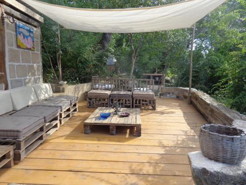 a patio with a couch and tables and a tent at Agriturismo Fontenuova in Saturnia