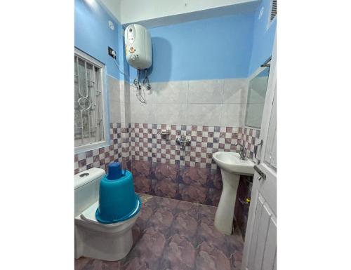 a bathroom with a toilet and a sink at HotelSonamTawang in Tawang