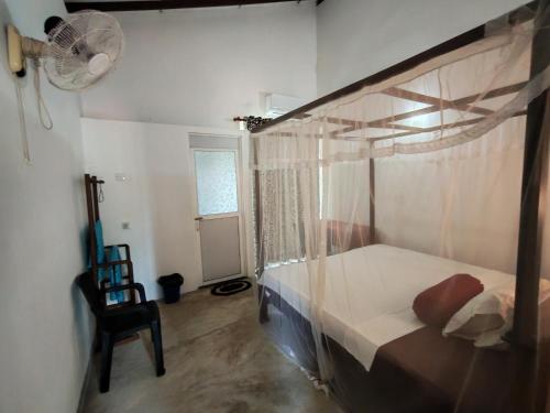 a bedroom with a bunk bed and a fan at Thaksilu Home in Mirissa