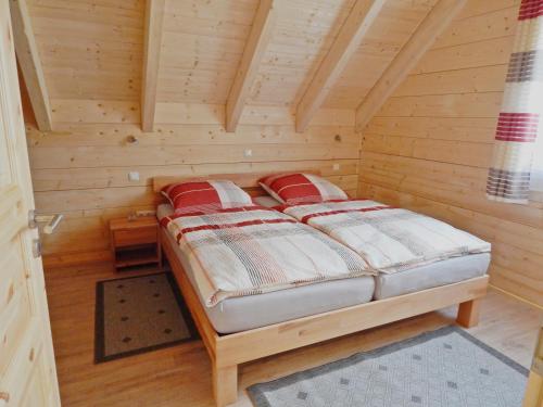 a bedroom with a bed in a wooden cabin at Holzblockhaus Stark in Kelheim