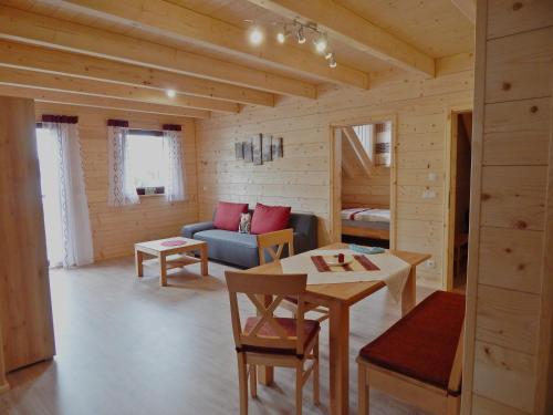 a living room with a couch and a table at Holzblockhaus Stark in Kelheim