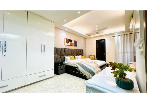 a living room with a bed and a couch at Olive Service Apartments - Greater Kailash in New Delhi
