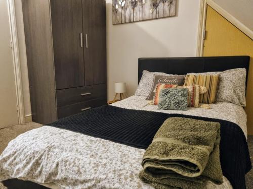 a bedroom with a bed with pillows and a closet at Loft Flat, near Hampton Court Palace, Free Parking in West Molesey