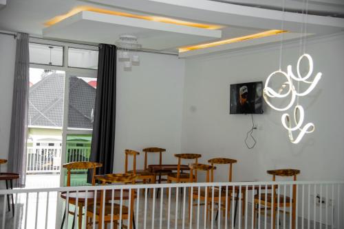 a dining room with wooden chairs and a table at Kibagabaga Homes Stay in Kigali