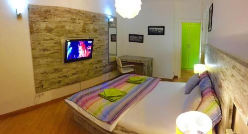 a bedroom with a bed and a tv on a wall at Vip apartment Beograd in Belgrade